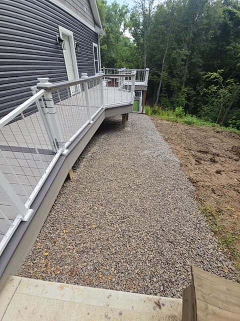 Gravel pathway installation along side of house with new deck