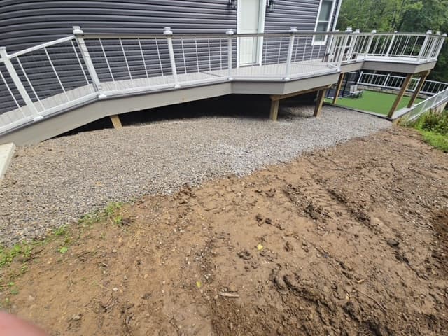 Gravel installation around deck with grading work