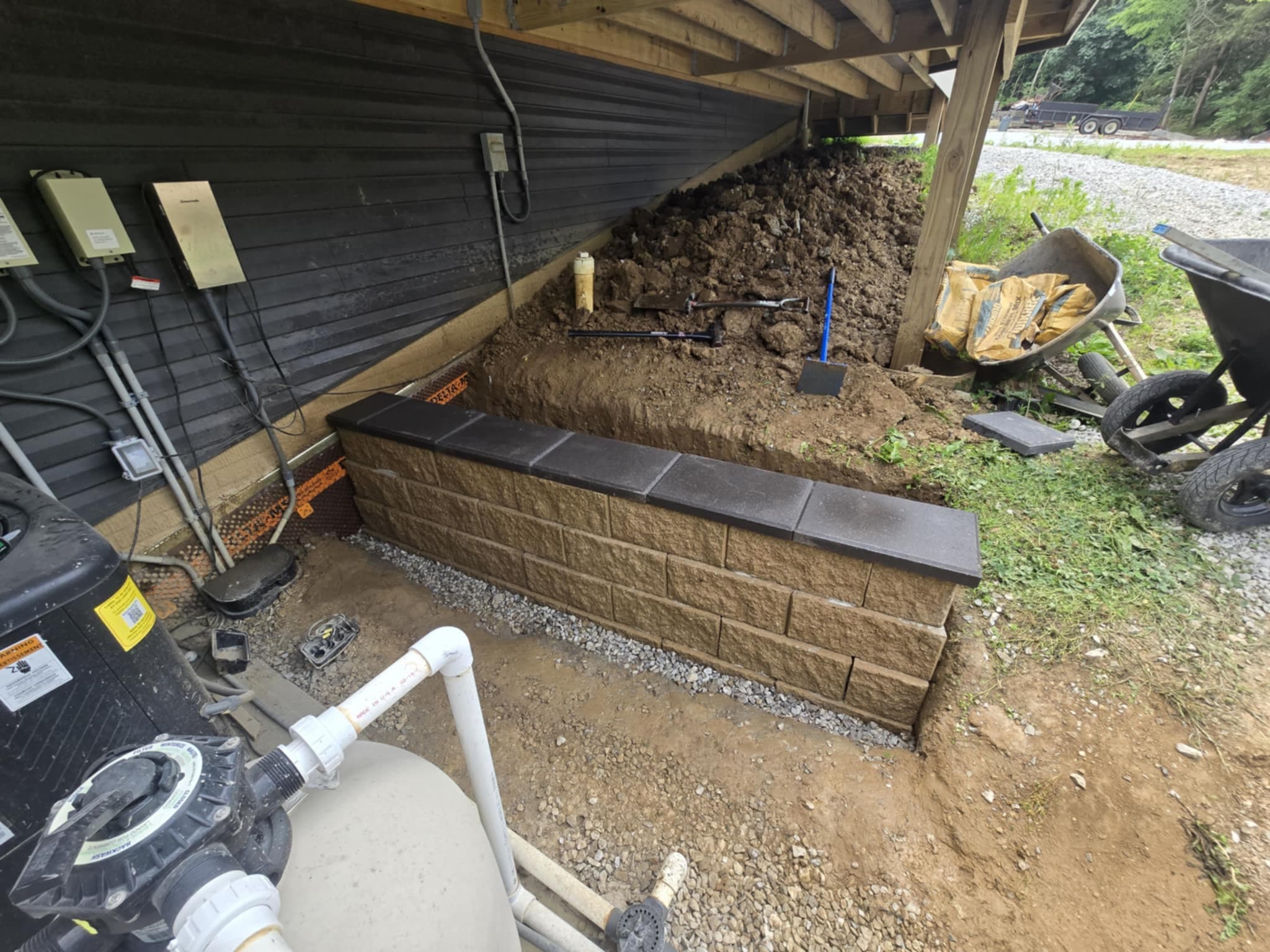 Completed decorative stone retaining wall with cap stones and drainage