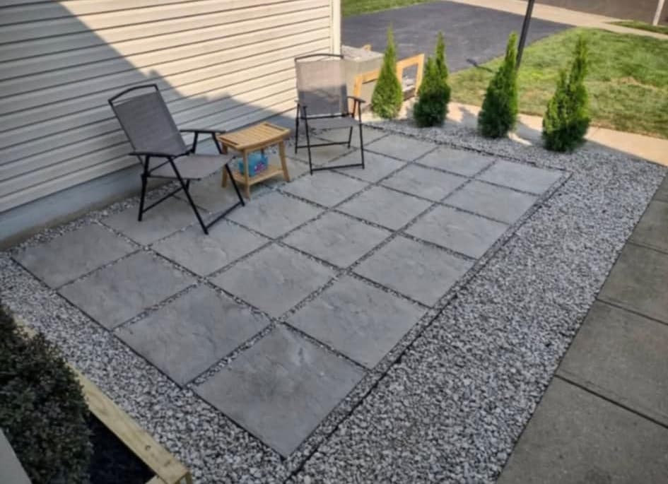 Stone paver patio with pea gravel joints and arborvitae plantings